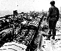 U.S. Army Ordnance units inspected bombed-out German supply trains.